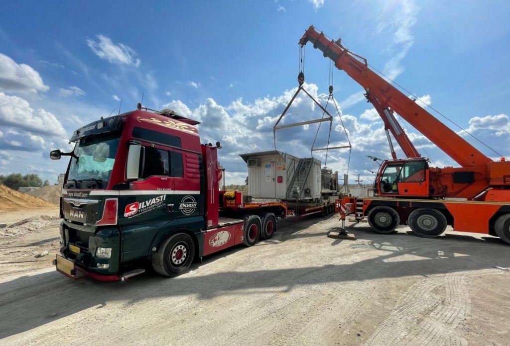 Silvasti Sp. z.o.o. red truck from Piła being loaded with a cargo.